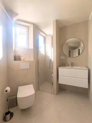 a bathroom with a toilet and a sink and a shower at Elegant Renovated Apartment Nice Port AC Sleeps 4 in Nice
