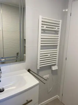 a white bathroom with a sink and a mirror at Cosy Nice Promenade des Anglais Beach Apartment 2 rooms in Nice