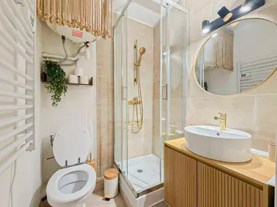 a bathroom with a toilet and a sink and a mirror at Proche mer - 2 pers, AC in Nice