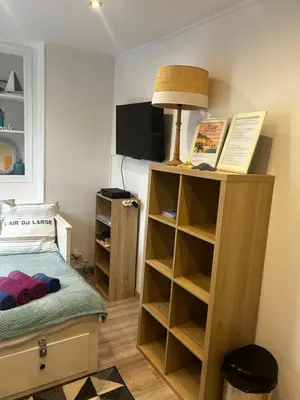 a small bedroom with a bed and a book shelf at Joli studio rénové vieux Nice in Nice
