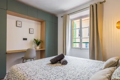 a bedroom with a bed with a towel on it at Bright 3 rooms apartment close to Place Massena in Nice
