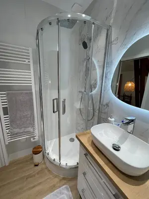 a white bathroom with a shower and a sink at Appartement Neuf Nice Carré Or à 2 pas de la mer tout équipé in Nice