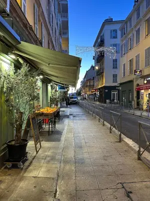 a sidewalk with a table and a tent on a street at Appartement Neuf Nice Carré Or à 2 pas de la mer tout équipé in Nice