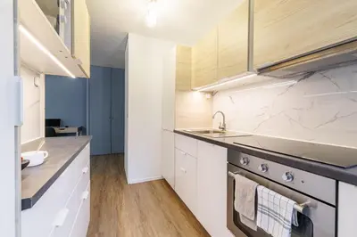 a kitchen with white cabinets and a sink at MY CASA - SUISSE - Cosy Apartment Down Town with terrasse in Nice