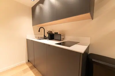 a small kitchen with a sink and a microwave at Charmant Duplex Vieux Nice, proche mer, WiFi, Clim in Nice