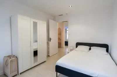a bedroom with a bed and a white cabinet at Bright apartment in Nice in Nice