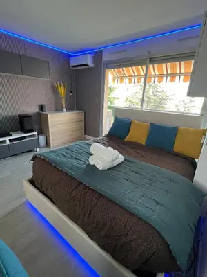 a bedroom with a large bed with a stuffed animal on it at Sea view appartment in Nice