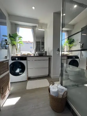 a bathroom with a sink and a washing machine at Sea view appartment in Nice