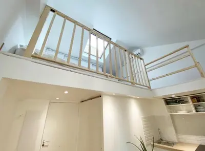 a stairway in a room with a balcony at Duplex studio 50 mètres de la plage in Nice