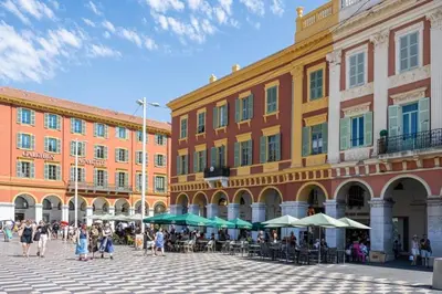 a group of people walking in a plaza in front of buildings at Le Notre Dame - 2 pièces au cœur de Nice in Nice