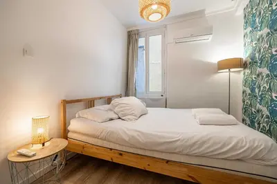 a bedroom with a bed and a table with a lamp at Cozy Apartment a-c 1BR-2P - Nice in Nice