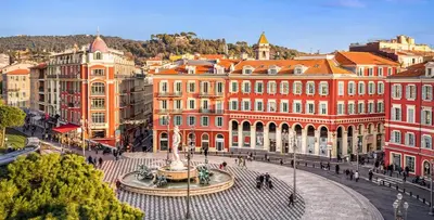 a group of buildings with a fountain in the middle of a street at T2design, élégant & calme à Nice in Nice