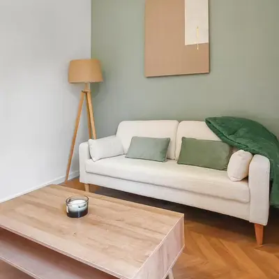 a living room with a white couch and a coffee table at T2design, élégant & calme à Nice in Nice