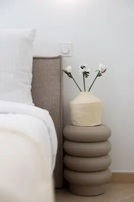 a vase with flowers in it next to a bed at Coup de cœur 3 couchages Quartier du Port in Nice