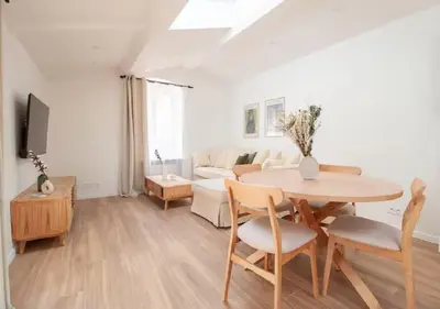 a living room with a table and a couch at Magnifique Confortable & Rénové au Port de Nice in Nice
