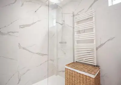 a bathroom with a glass shower with a wicker basket at Magnifique Confortable & Rénové au Port de Nice in Nice