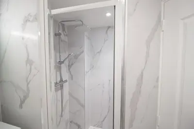 a shower with a glass door in a bathroom at Confort, modernité & calme au Port de Nice in Nice