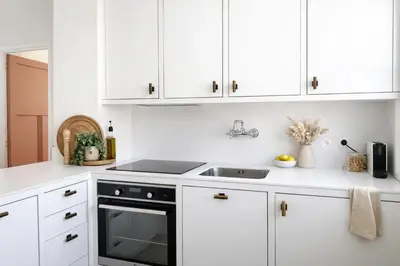 a kitchen with a white counter and a tile floor at Magnifique 3P au port in Nice
