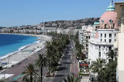 a living room with a television and a white door at WeHost BARETY - Blooming Balcony Retreat - Central 3-4prs in Nice