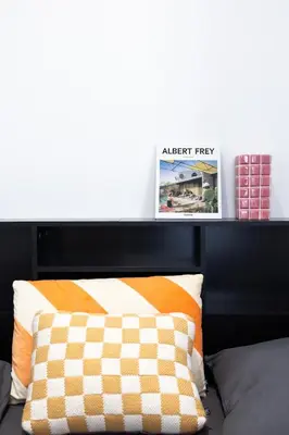 a bed with a black headboard with two pictures on it at Studio Cosy et confortable hyper centre in Nice