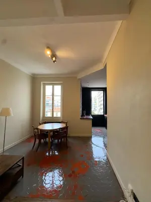 an empty living room with a table and chairs at Renovated 2-room apartment Sleeps 4 Tram and shops nearby in Nice