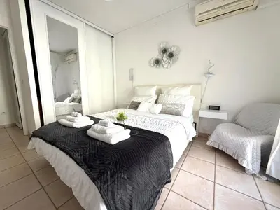 a bedroom with a large bed with towels on it at Le MIAMI in Nice