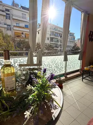 a bottle of wine sitting on a table on a balcony at Le MIAMI in Nice