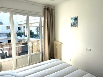 a bedroom with a bed and a large window at Hyper centre massena in Nice
