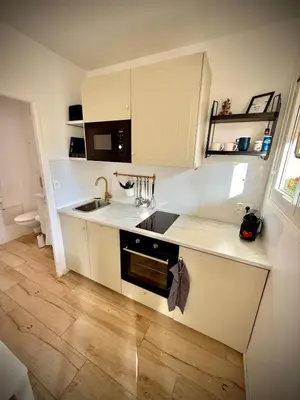 a small kitchen with a sink and a stove at Charmant studio avec terrasse pour amoureux in Nice
