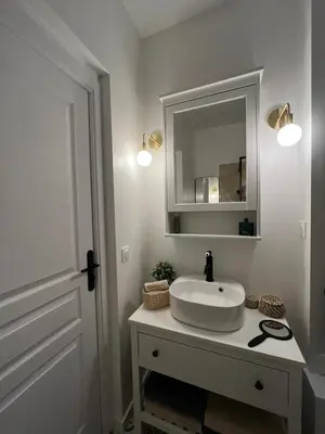 a white bathroom with a sink and a mirror at Nice Boheme in Nice
