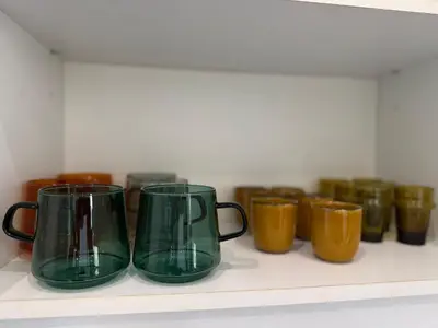 a row of green vases sitting on a shelf at La Rotonde Art,elegance & romantisme au Coeur de Nice, à 2 pas du Negresco in Nice