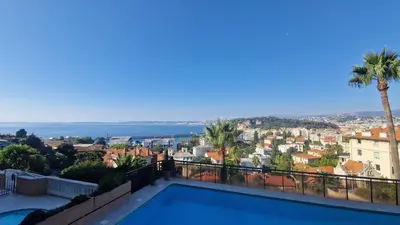 a villa with a swimming pool and a view of the ocean at Nice Mont Boron proche du Port in Nice