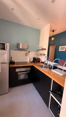 a kitchen with a wooden counter top and a sink at Living Nice and French Riviera in Nice