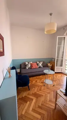 a living room with a couch and a wooden floor at Living Nice and French Riviera in Nice