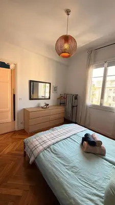 a bedroom with a large bed with a blue blanket at Living Nice and French Riviera in Nice