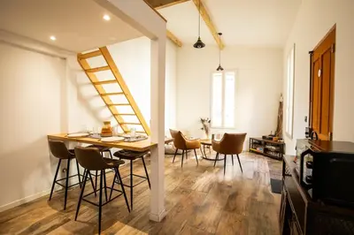 a kitchen and dining room with a wooden table and chairs at Dolce Vita Clemenceau - Nice City Center 4 People in Nice