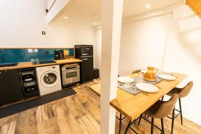 a kitchen and dining room with a table and a washing machine at Dolce Vita Clemenceau - Nice City Center 4 People in Nice
