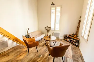 a living room with a couch and a table and chairs at Dolce Vita Clemenceau - Nice City Center 4 People in Nice
