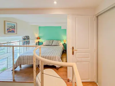 a bedroom with a bed and a staircase in a room at Place Grimaldi - Wifi, AC, 3pers in Nice