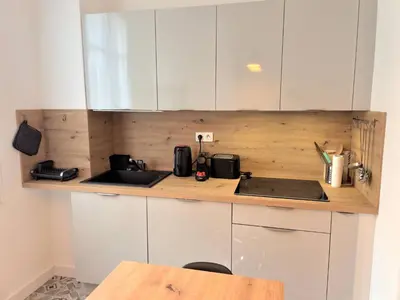 a kitchen with white cabinets and a sink at Bright apartment Nice harbour in Nice