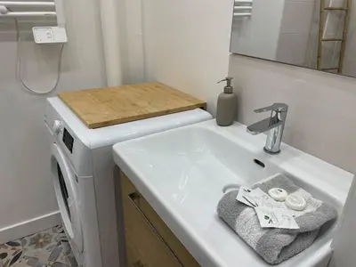 a bathroom with a sink and a washing machine at Bright apartment Nice harbour in Nice