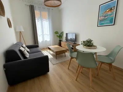 a living room with a couch and a table at Bright apartment Nice harbour in Nice