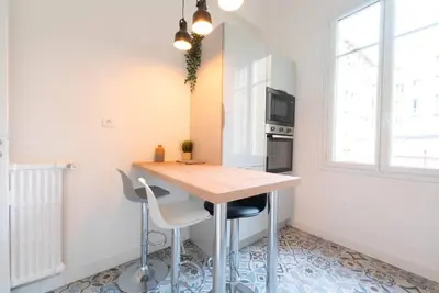 a kitchen with a wooden table and two chairs at Bright apartment Nice harbour in Nice