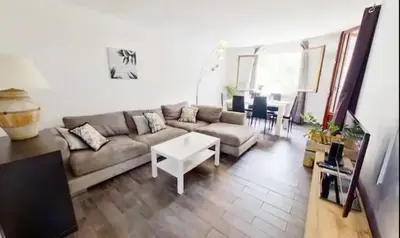 a living room with a couch and a table at Nice collines in La Trinité
