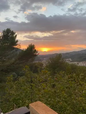 a sunset on a hill with trees and the horizon at Nice collines in La Trinité