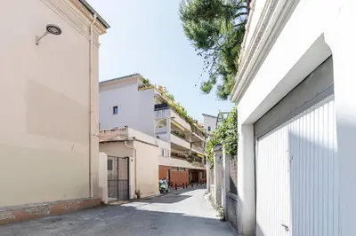 an alley between two buildings with a white building at Studio Cosy Mezzanine 2-4p Carré d'Or in Nice
