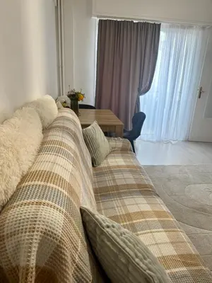 a couch in a living room with a table at Studio Lumiere Nice Center in Nice