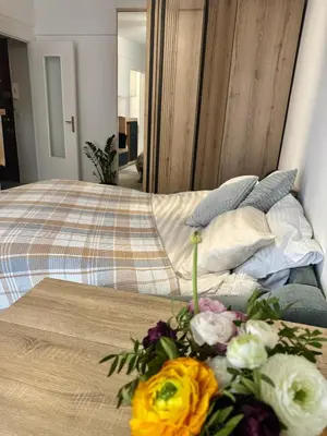 a bed with a bouquet of flowers on top of it at Studio Lumiere Nice Center in Nice