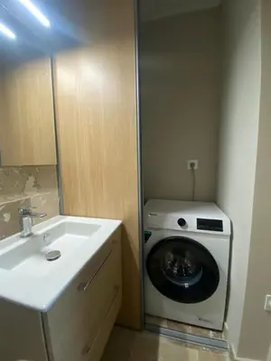 a bathroom with a washing machine and a sink at Duplex cosy sur Nice Libération in Nice