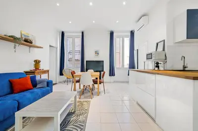a living room with a blue couch and a table at Nice Renting - GRIMALDI - Golden Square Best Location Fully Equiped in Nice